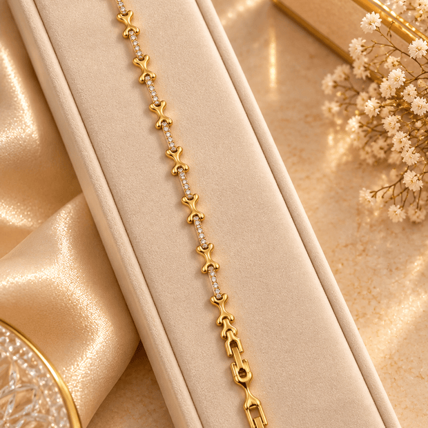 Bhavmayi gold-tone linked bracelet featuring curved decorative links and a central row of clear stone-like accents - bhavmayi
