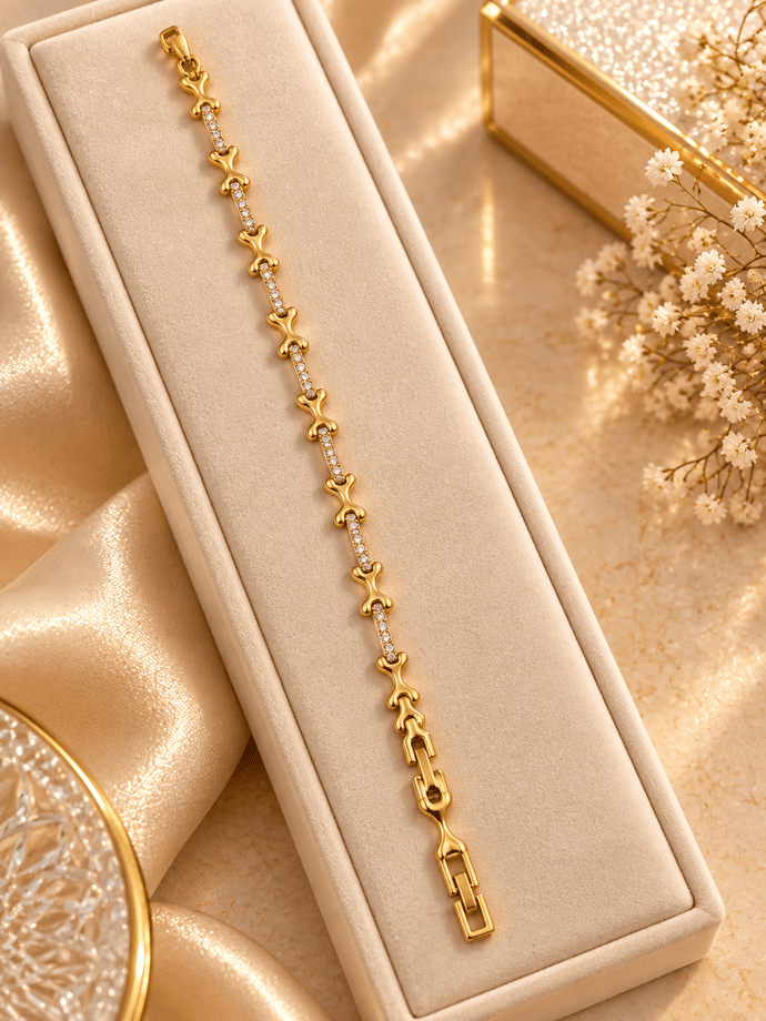 Bhavmayi gold-tone linked bracelet featuring curved decorative links and a central row of clear stone-like accents - bhavmayi