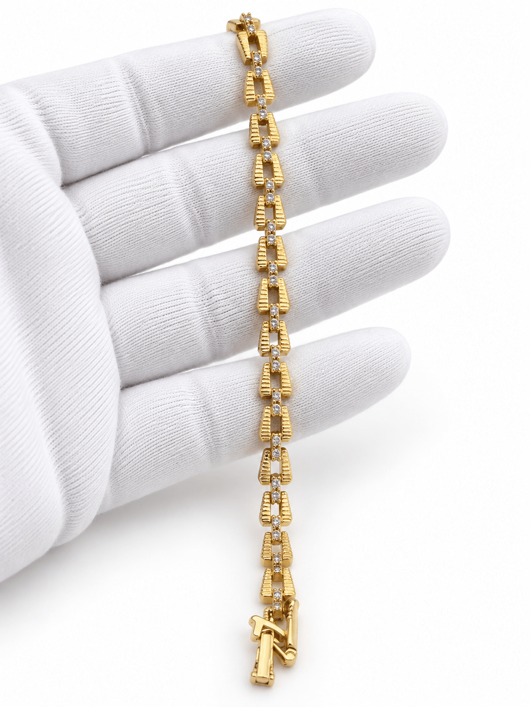 Bhavmayi gold-tone linked bracelet featuring curved decorative links and a central row of clear stone-like accents - bhavmayi