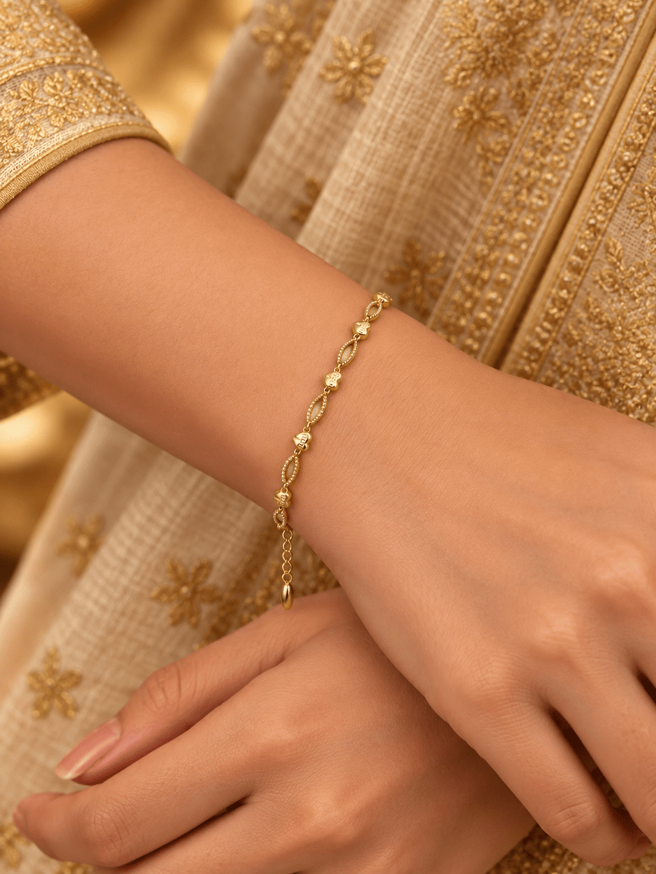 Bhavmayi gold-tone marquise link bracelet with clear reflective accents and geometric connector details - bhavmayi