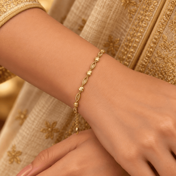 Bhavmayi gold-tone marquise link bracelet with clear reflective accents and geometric connector details - bhavmayi