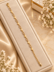 Bhavmayi gold-tone marquise link bracelet with clear reflective accents and geometric connector details - bhavmayi