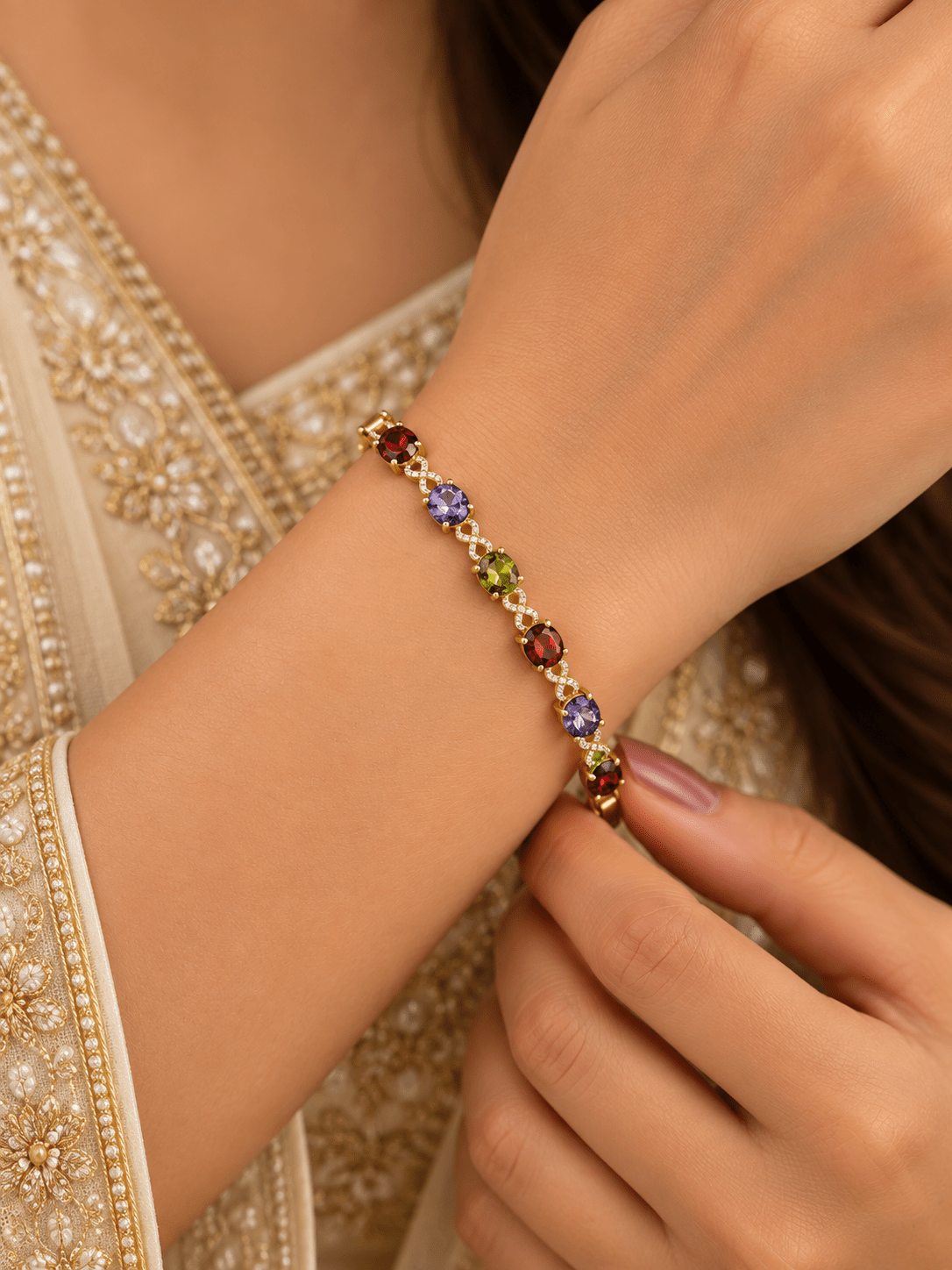 Golden-toned multicolor bracelet with red purple and green oval accents and clear decorative link details