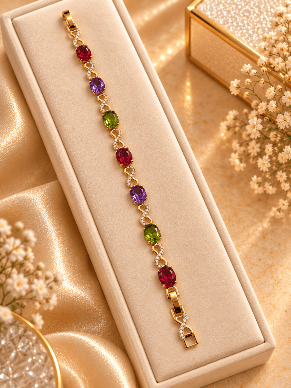 Golden-toned multicolor bracelet with red purple and green oval accents and clear decorative link details