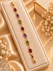 Golden-toned multicolor bracelet with red purple and green oval accents and clear decorative link details