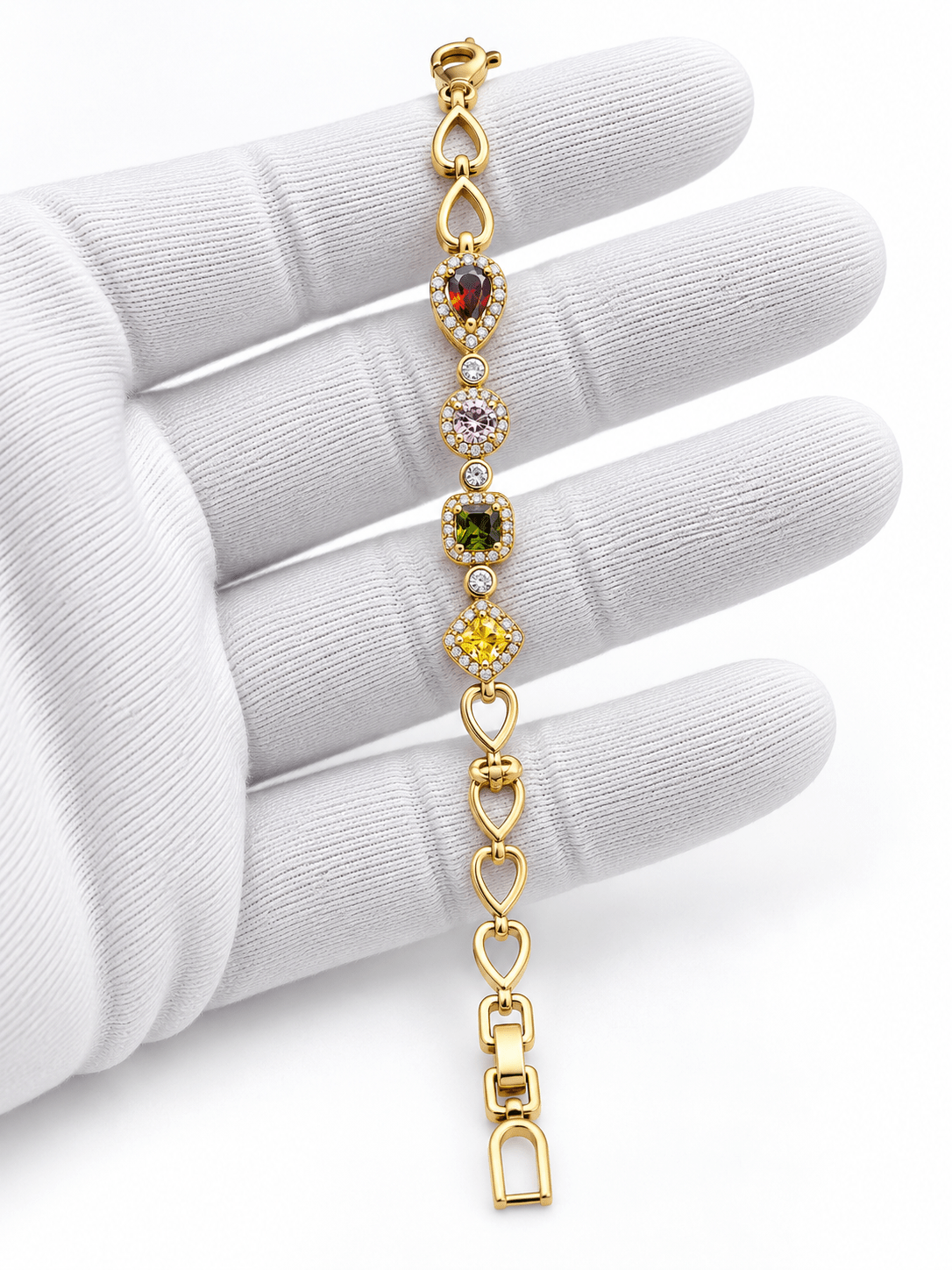 Golden oval link bracelet with deep red pink and amber-brown coloured accents and clear decorative borders