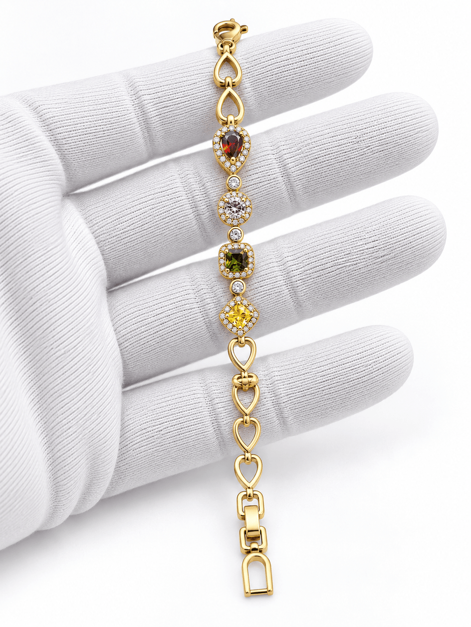 Golden oval link bracelet with deep red pink and amber-brown coloured accents and clear decorative borders