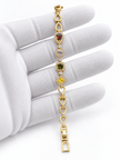 Golden oval link bracelet with deep red pink and amber-brown coloured accents and clear decorative borders