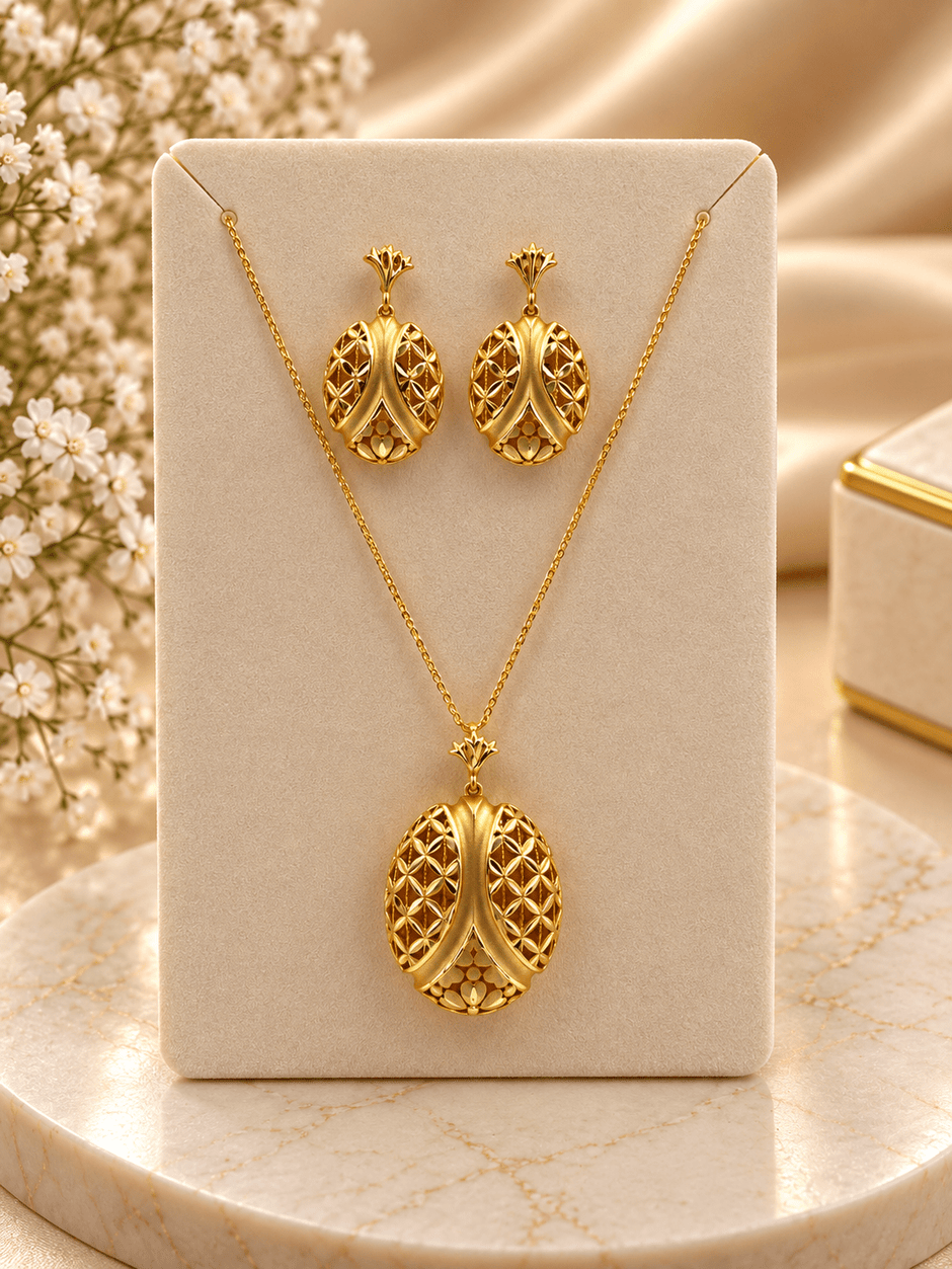 Bhavmayi gold-tone necklace and matching earrings featuring elongated leaf motifs with intricate open lattice detailing - bhavmayi