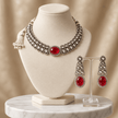 Bhavmayi gold-tone necklace set with green oval stones, white decorative accents and matching drop earrings - bhavmayi