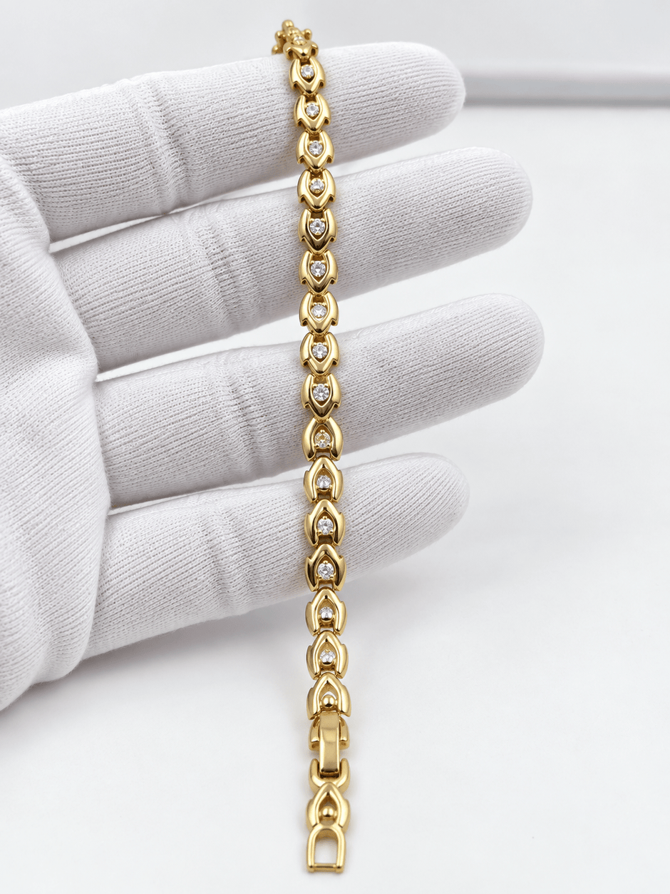 Bhavmayi gold-tone oval link bracelet with repeating clear accents and rounded decorative connectors - bhavmayi