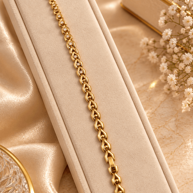 Bhavmayi gold-tone oval link bracelet with repeating clear accents and rounded decorative connectors - bhavmayi