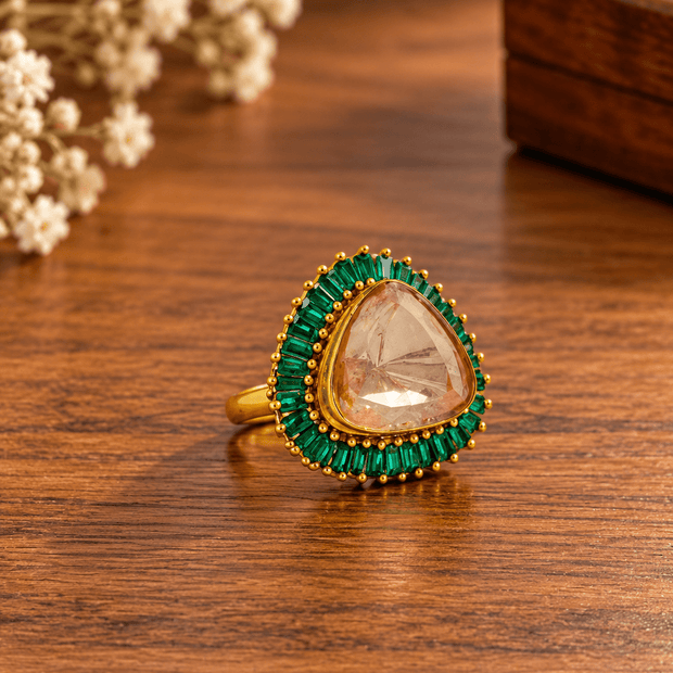 Bhavmayi gold-tone statement ring with green rectangular stones surrounding a large rounded triangular centre - bhavmayi