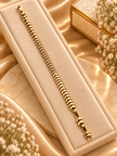Bhavmayi golden link bracelet with curved embellished motifs, geometric clear accents and a visible clasp