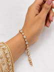 Bhavmayi golden link bracelet with curved embellished motifs, geometric clear accents and a visible clasp