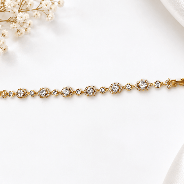 Bhavmayi golden link bracelet with curved embellished motifs, geometric clear accents and a visible clasp