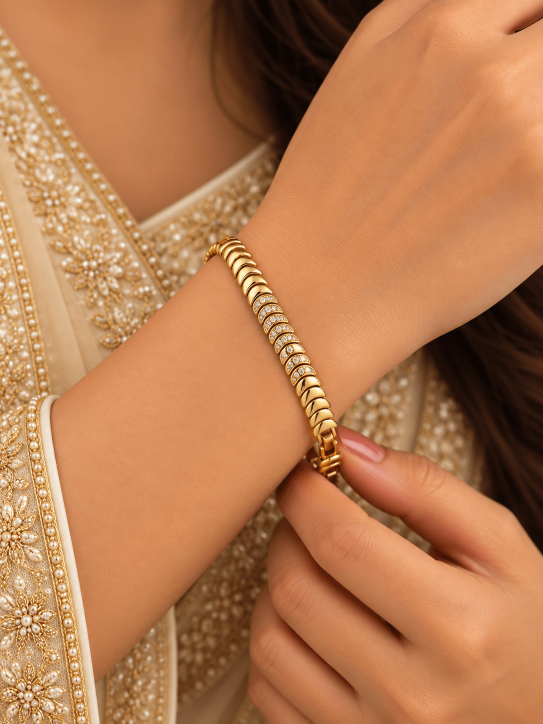 Bhavmayi golden link bracelet with curved embellished motifs, geometric clear accents and a visible clasp