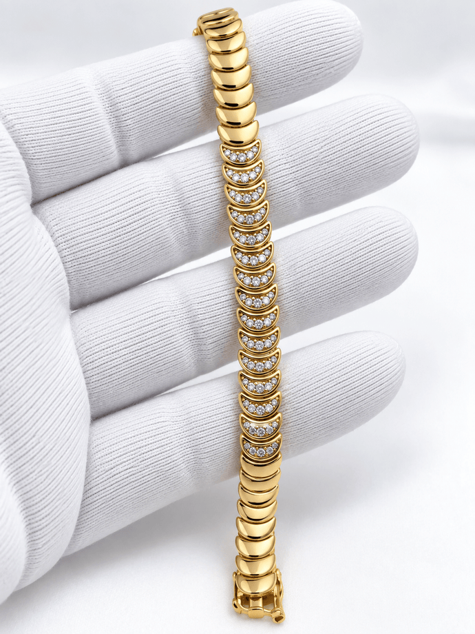 Bhavmayi golden link bracelet with curved embellished motifs, geometric clear accents and a visible clasp