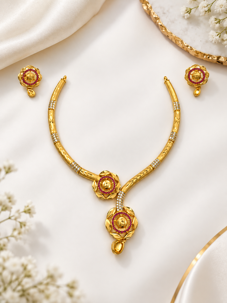 Gold-tone necklace set with purple circular stone motifs, clear stone detailing and matching dangling earrings on a white background.