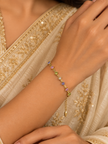 Gold-tone chain bracelet featuring geometric golden links and multicoloured blue, purple, pink, green and clear decorative accents, shown separately and worn on a wrist.