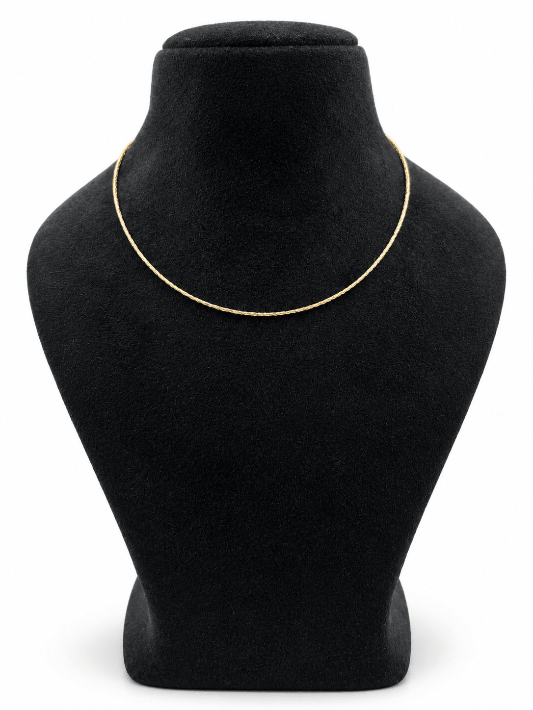 Delicate gold-tone chain necklace with closely linked textured detailing, displayed in multiple loops on a white background and worn around the neck on a black jewellery bust. - bhavmayi