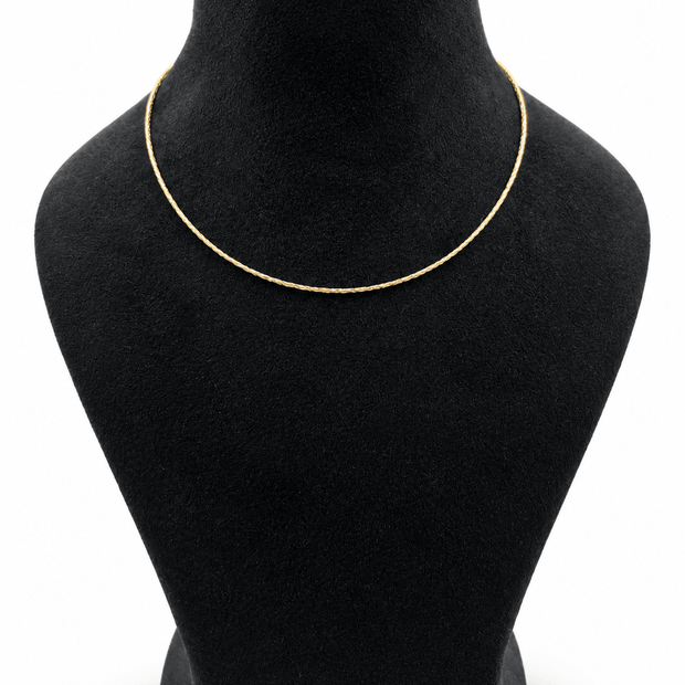 Golden multi-strand necklace with fine twisted textured chains and a layered appearance