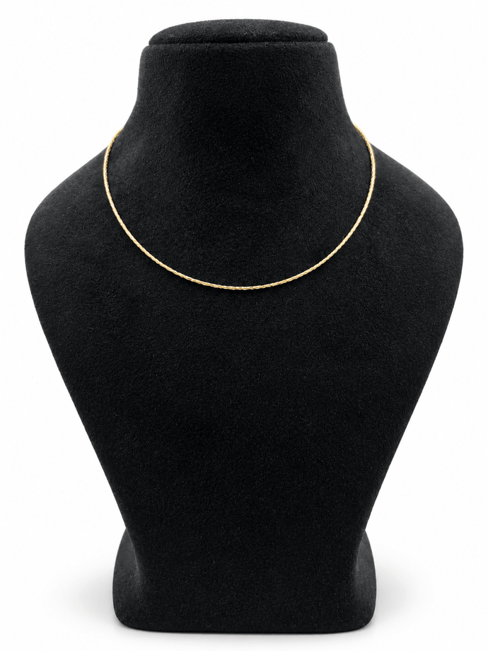 Delicate gold-tone chain necklace with closely linked textured detailing, displayed in multiple loops on a white background and worn around the neck on a black jewellery bust. - bhavmayi