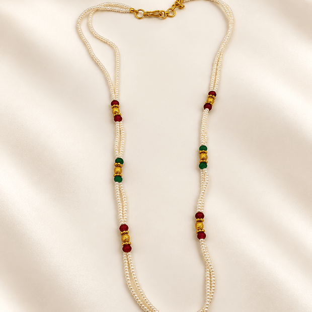 Bhavmayi traditional multi-strand ivory pearl necklace set with maroon and dark green bead accents, gold-tone earrings.