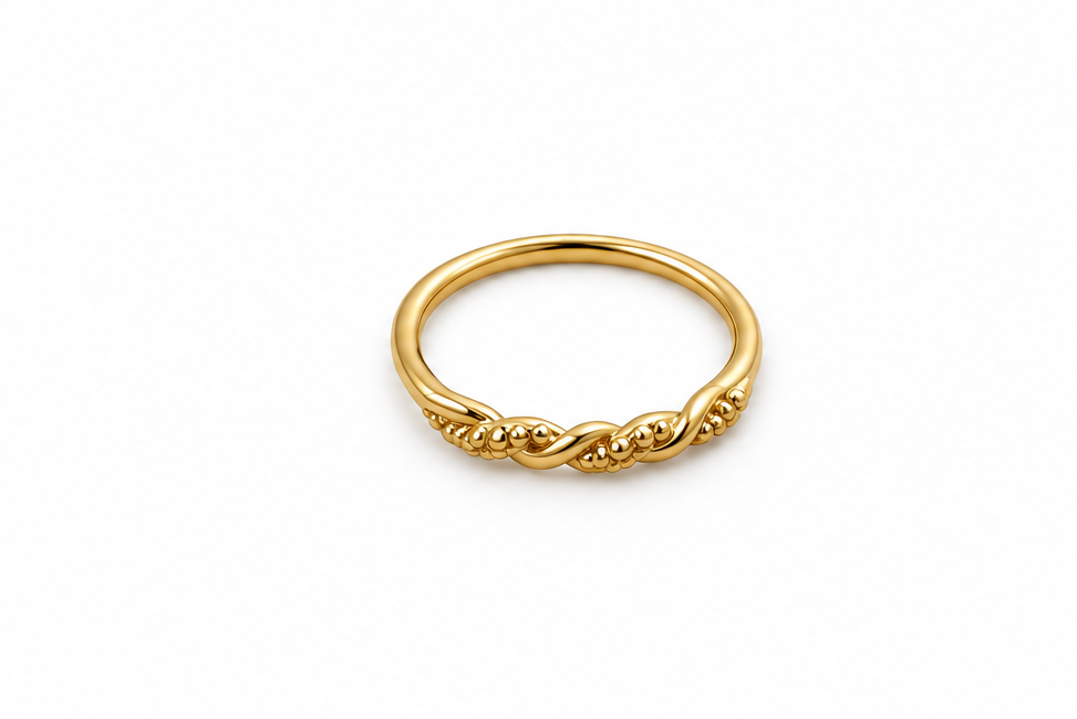 Gold-tone ring with a slender band, flowing interlacing wave pattern and small clear reflective accents, displayed on a white background and worn on a finger.