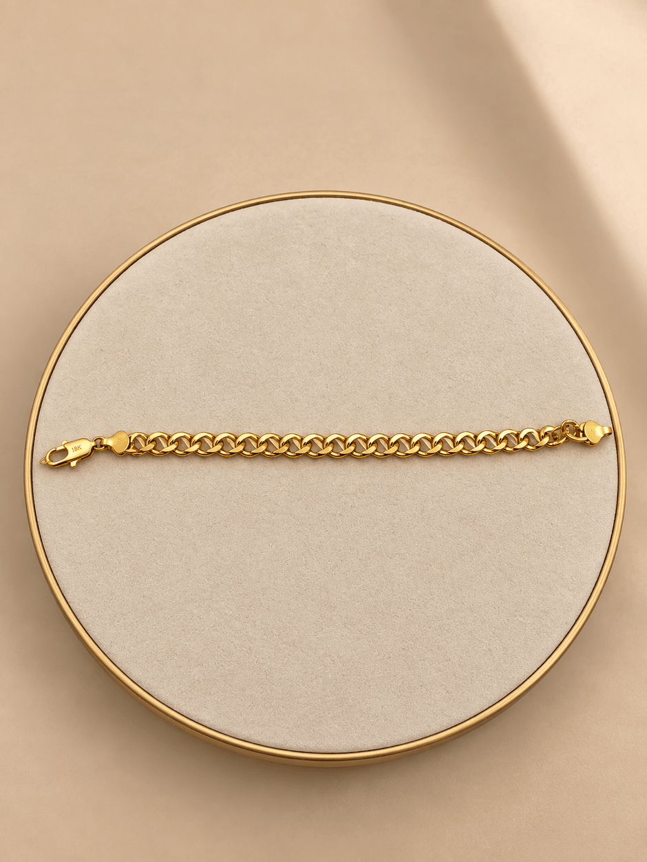 Gold-tone bracelet featuring a continuous chain of rounded interlocking links with a twisted appearance, shown separately and worn around a woman's wrist. - bhavmayi