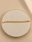Gold-tone bracelet featuring a continuous chain of rounded interlocking links with a twisted appearance, shown separately and worn around a woman's wrist. - bhavmayi