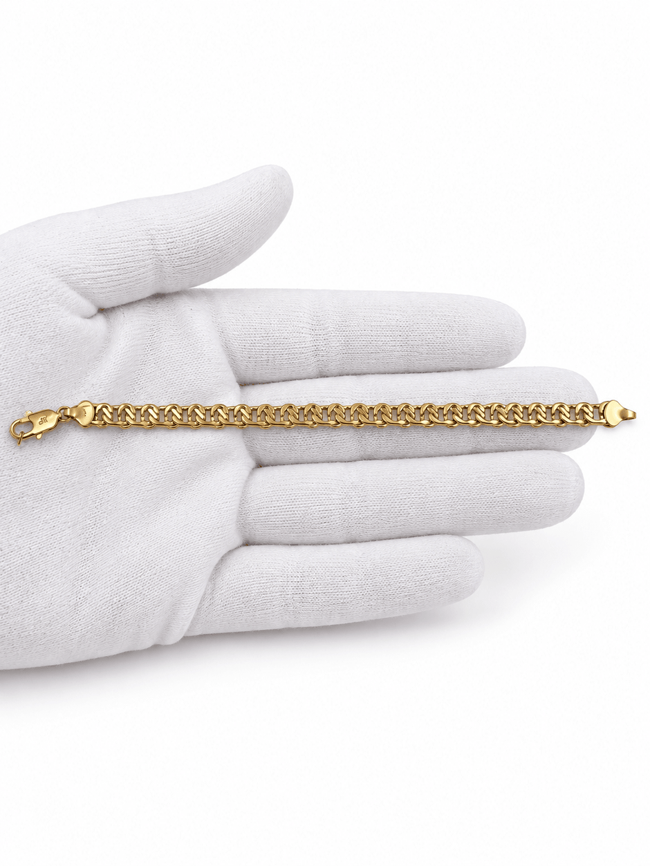 Gold-tone bracelet featuring a continuous chain of rounded interlocking links with a twisted appearance, shown separately and worn around a woman's wrist. - bhavmayi