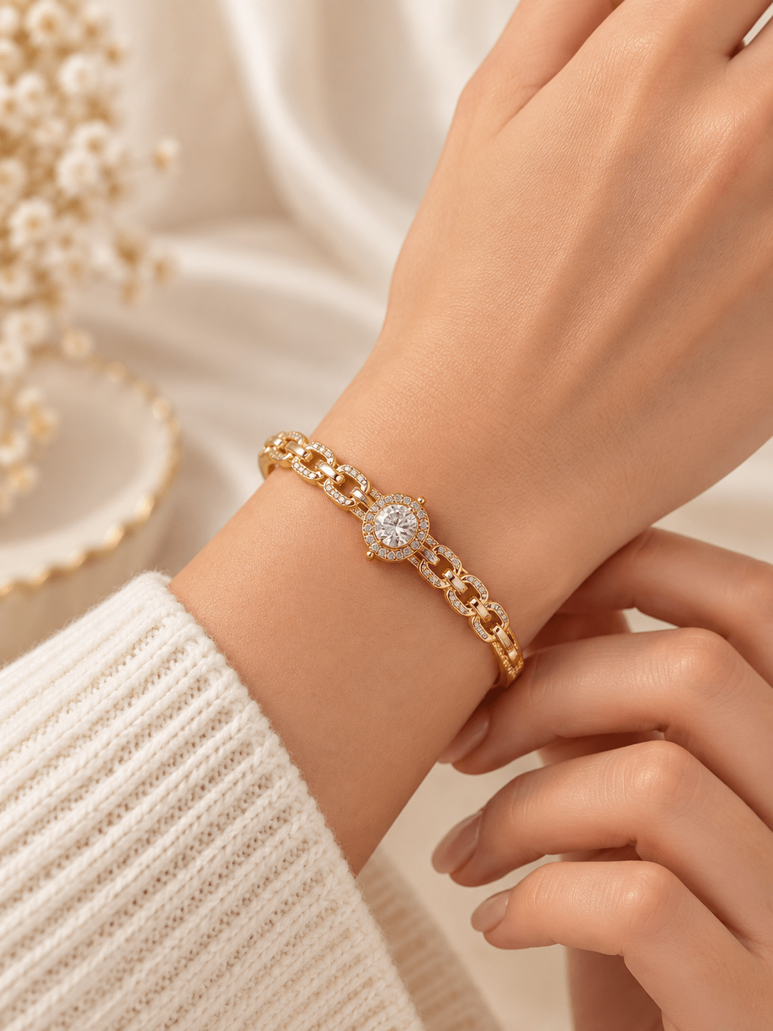 Gold-tone bracelet with a square-shaped central motif, large clear faceted centrepiece, surrounding rows of small clear decorative stones and an intricate openwork linked band. - bhavmayi