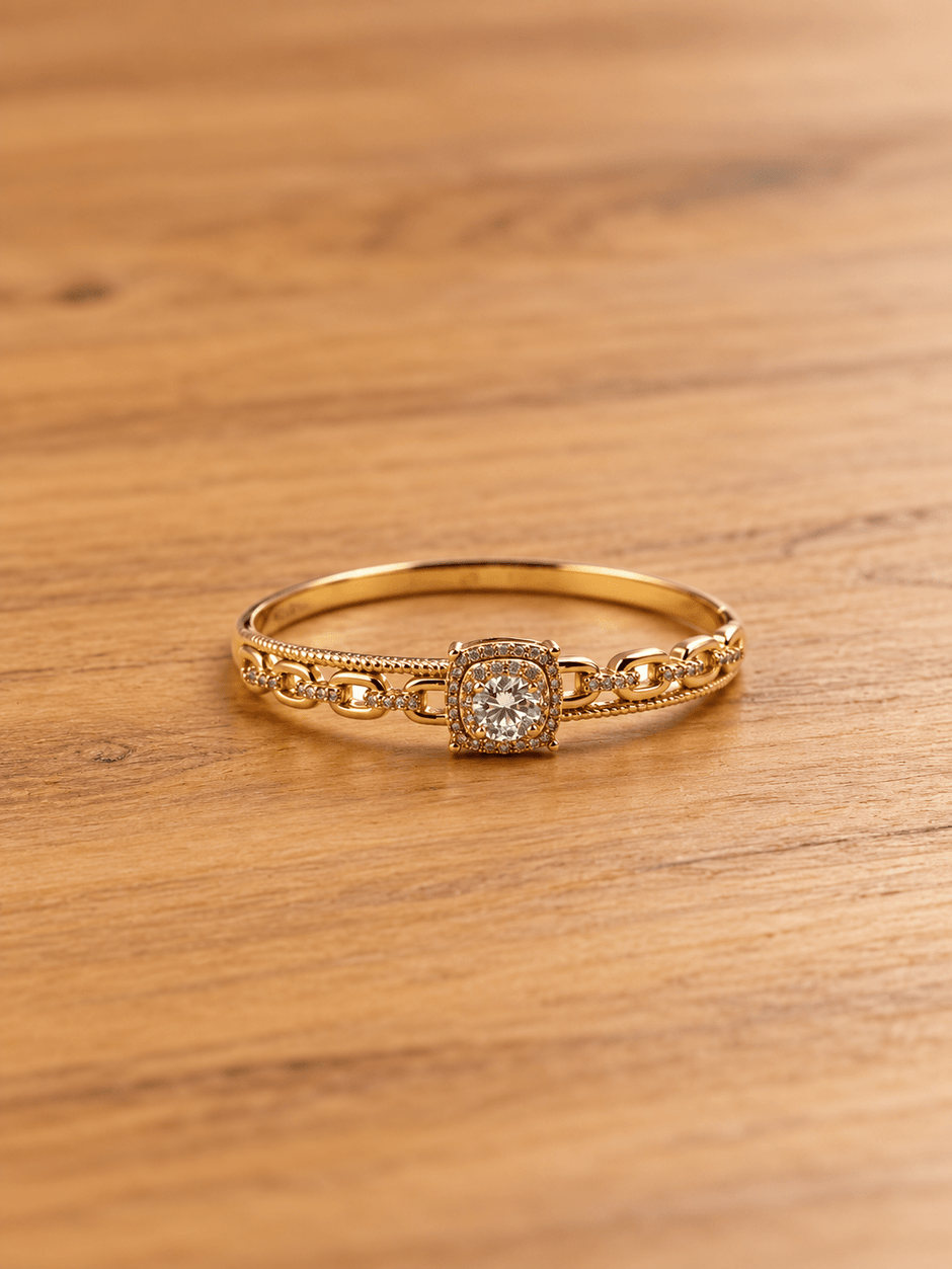 Gold-tone bracelet with a square-shaped central motif, large clear faceted centrepiece, surrounding rows of small clear decorative stones and an intricate openwork linked band. - bhavmayi