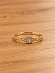 Gold-tone bracelet with a square-shaped central motif, large clear faceted centrepiece, surrounding rows of small clear decorative stones and an intricate openwork linked band. - bhavmayi