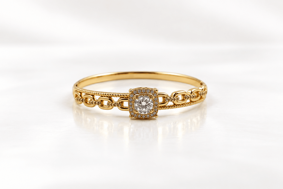 Gold-tone bracelet with a square-shaped central motif, large clear faceted centrepiece, surrounding rows of small clear decorative stones and an intricate openwork linked band. - bhavmayi