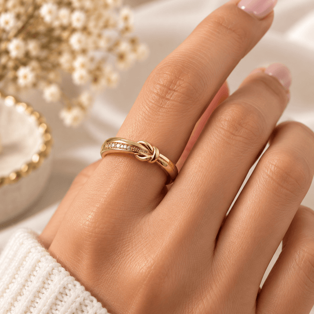 Bhavmayi golden knot design ring with a row of clear accent details shown on a finger