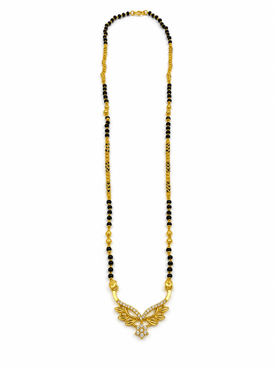Gold-tone mangalsutra necklace with black bead chain, symmetrical leaf-shaped centerpiece, clear stone embellishments and a decorative central drop detail, displayed on a white background. - bhavmayi