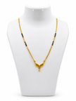 Gold-tone mangalsutra necklace with black beads, symmetrical floral leaf-shaped centerpiece, clear decorative stones, red center accent, and dangling teardrop pendant on a white background. - bhavmayi