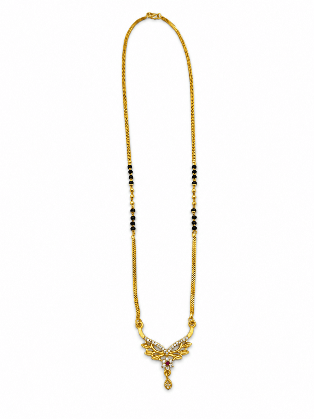 Gold-tone mangalsutra necklace with black beads, symmetrical floral leaf-shaped centerpiece, clear decorative stones, red center accent, and dangling teardrop pendant on a white background. - bhavmayi