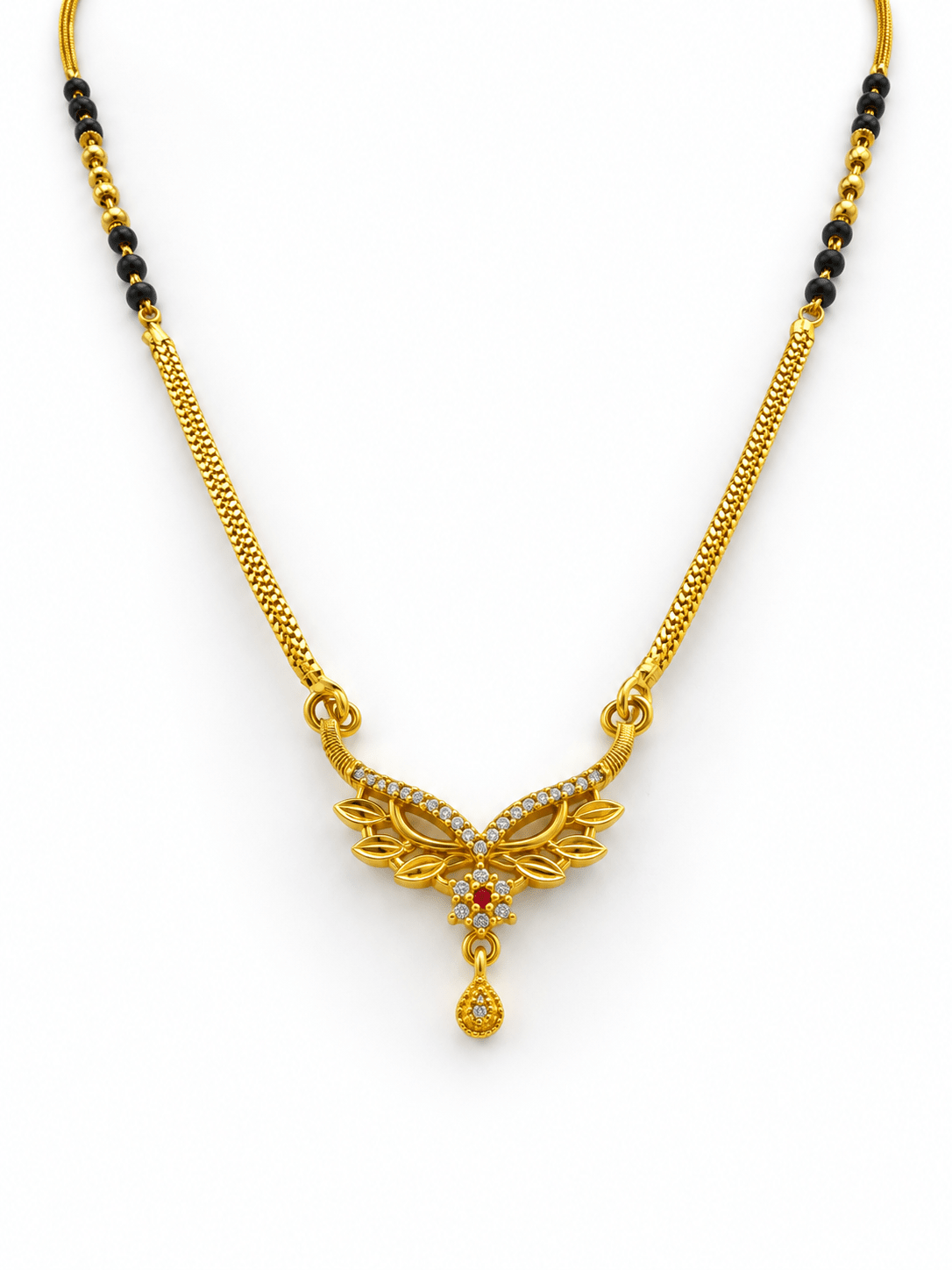 Gold-tone mangalsutra necklace with black beads, symmetrical floral leaf-shaped centerpiece, clear decorative stones, red center accent, and dangling teardrop pendant on a white background. - bhavmayi