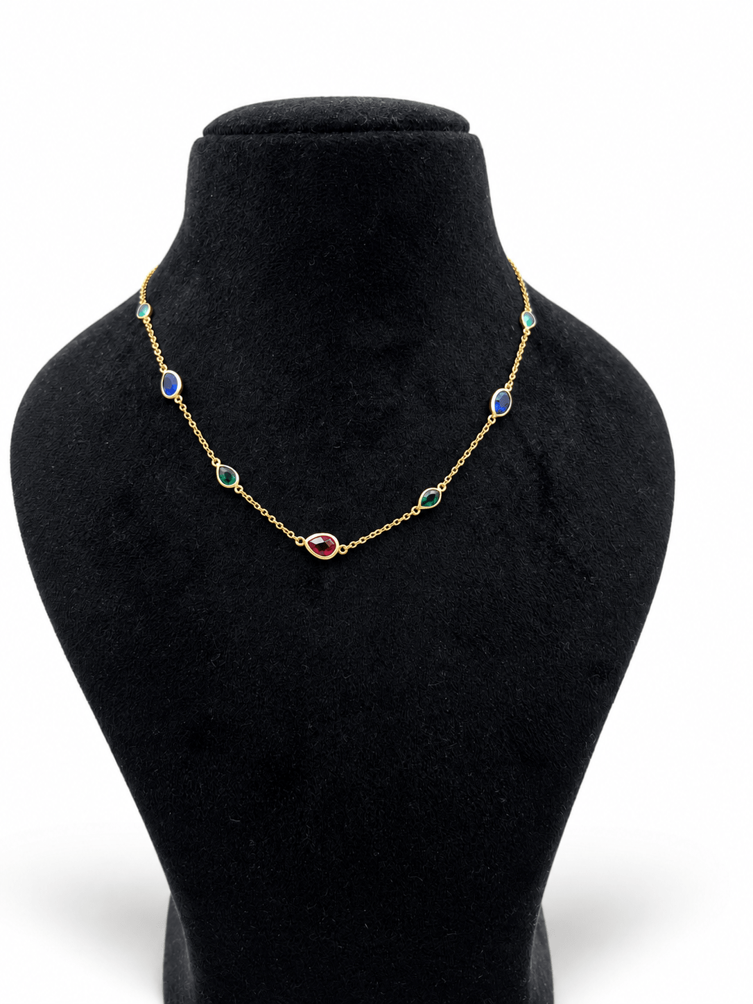 Gold-tone necklace and matching bracelet featuring delicate chains with spaced blue, teal green and burgundy red decorative accents, displayed on a model and separately. - bhavmayi