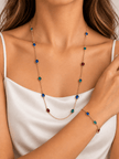 Gold-tone necklace and matching bracelet featuring delicate chains with spaced blue, teal green and burgundy red decorative accents, displayed on a model and separately. - bhavmayi