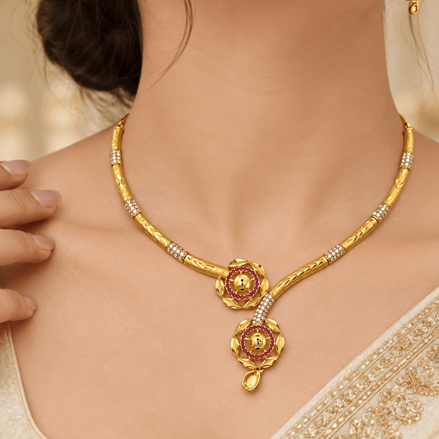 Bhavmayi golden-toned floral necklace and matching earrings with red accent circles and clear decorative details
