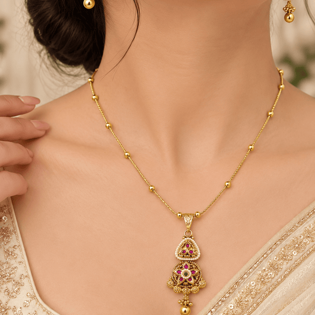 Bhavmayi golden-toned teardrop pendant necklace and matching earrings with green and pink-red accent details