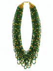 Green beaded necklace with small gold-tone connecting elements and a gold-tone clasp, displayed in a rounded elongated shape on a white jewellery display and against an elegant neutral background. - bhavmayi