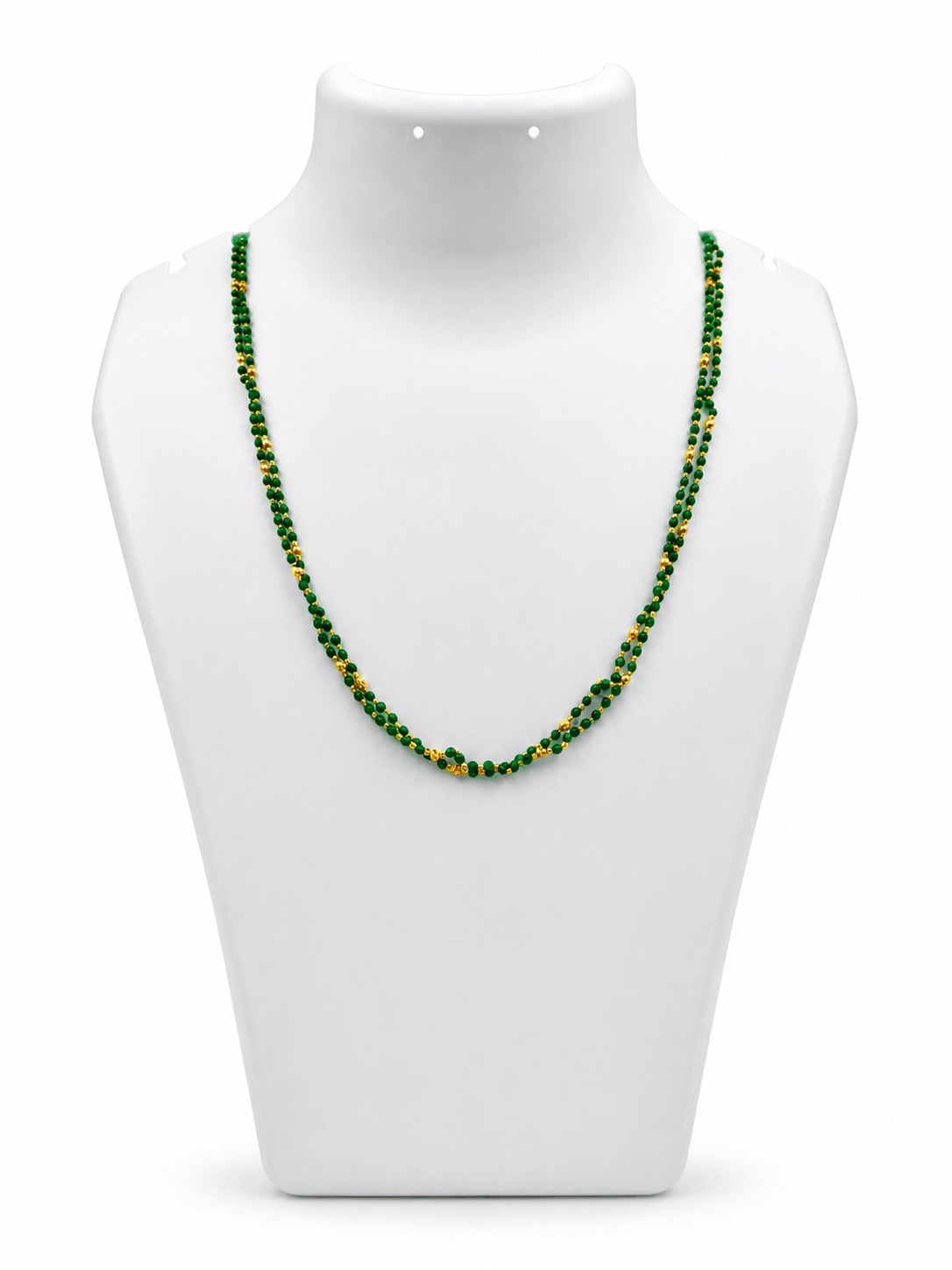 Green beaded necklace with small gold-tone connecting elements and a gold-tone clasp, displayed in a rounded elongated shape on a white jewellery display and against an elegant neutral background. - bhavmayi