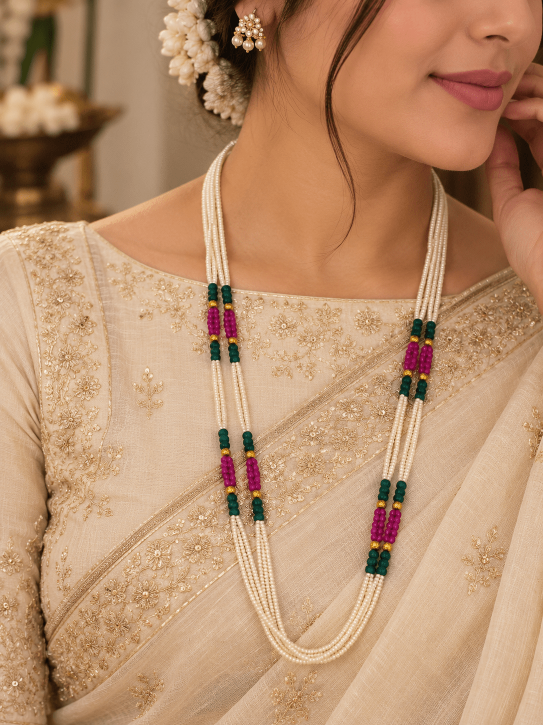 Long multistrand ivory-white pearl-style beaded necklace with green and magenta pink bead sections, gold-tone decorative accents and a hook-style clasp, shown from two angles. - bhavmayi