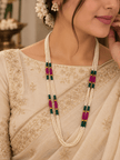 Long multistrand ivory-white pearl-style beaded necklace with green and magenta pink bead sections, gold-tone decorative accents and a hook-style clasp, shown from two angles. - bhavmayi