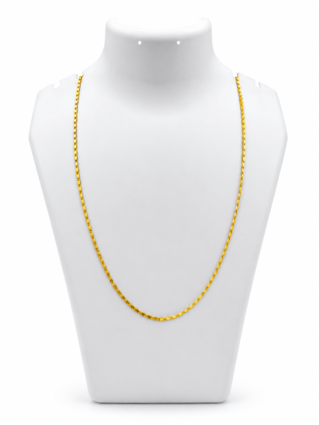Slender golden chain necklace with repeating small geometric links displayed in a U shape and on a white necklace bust. - bhavmayi